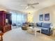 Relaxing living room featuring a blue sofa, recliner, and view to balcony at 426 Bouchelle Dr # 303, New Smyrna Beach, FL 32169