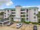 Condo building showcasing covered parking and landscaping at 426 Bouchelle Dr # 303, New Smyrna Beach, FL 32169