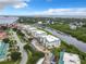 Aerial view showcasing condo building near waterway and marina at 426 Bouchelle Dr # 303, New Smyrna Beach, FL 32169