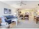 Open living space with sofa, chairs, and views of dining and kitchen area at 426 Bouchelle Dr # 303, New Smyrna Beach, FL 32169