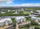 Drone view of condo building with water access and parking at 426 Bouchelle Dr # 303, New Smyrna Beach, FL 32169
