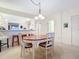 Well-lit dining area with an oval wooden table and chairs, open to the kitchen at 426 Bouchelle Dr # 303, New Smyrna Beach, FL 32169