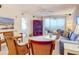 Spacious living room with a comfy sofa, wicker chairs, and access to a balcony at 426 Bouchelle Dr # 303, New Smyrna Beach, FL 32169