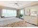 King bedroom with dresser, balcony access, and seating at 426 Bouchelle Dr # 303, New Smyrna Beach, FL 32169