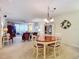 Bright dining room with oval table and chairs, offering views into the living room and kitchen at 426 Bouchelle Dr # 303, New Smyrna Beach, FL 32169