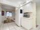 White kitchen with appliances and view into dining area at 426 Bouchelle Dr # 303, New Smyrna Beach, FL 32169