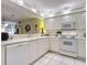 White kitchen with appliances and view into living area at 426 Bouchelle Dr # 303, New Smyrna Beach, FL 32169