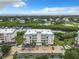 Condo building nestled beside a tranquil waterway, aerial view at 426 Bouchelle Dr # 303, New Smyrna Beach, FL 32169