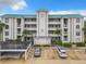 Three-story condo building with green roof, landscaping, and parking at 426 Bouchelle Dr # 303, New Smyrna Beach, FL 32169