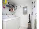 Clean laundry room, featuring a washer, dryer, and storage shelves at 426 Bouchelle Dr # 303, New Smyrna Beach, FL 32169
