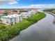 Aerial view of condo building and waterway, showcasing desirable waterfront location at 426 Bouchelle Dr # 303, New Smyrna Beach, FL 32169