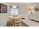 Cozy dining area with white table and chairs near entry at 426 Bouchelle Dr # 303, New Smyrna Beach, FL 32169