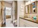 Bathroom with granite countertop, tiled shower, and updated vanity at 300 Quay Assisi Ct, New Smyrna Beach, FL 32169
