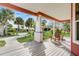 Front porch with rocking chairs and view of the yard at 300 Quay Assisi Ct, New Smyrna Beach, FL 32169
