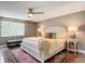 Spacious main bedroom with a comfortable bed, nightstands, and ceiling fan at 813 E 13Th Ave, New Smyrna Beach, FL 32169