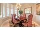 Elegant dining room with a large table, chandelier, and plantation shutters at 728 Sea Duck Dr, Daytona Beach, FL 32119