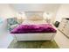 Main bedroom with king-size bed and purple blanket at 840 Center Ave # 840, Daytona Beach, FL 32117