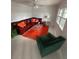 Living room with L-shaped sofa, orange rug, and green accent chair at 840 Center Ave # 840, Daytona Beach, FL 32117