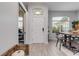 Spacious entryway with wood-look floors, a white door and a view into dining area at 1768 Creekwater Blvd, Port Orange, FL 32128