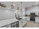 Bright kitchen with white cabinets, quartz island, and stainless steel appliances at 1768 Creekwater Blvd, Port Orange, FL 32128