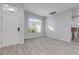 Bright living room with wood-look tile flooring and large window at 1768 Creekwater Blvd, Port Orange, FL 32128