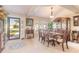 Bright dining room with wood table and chairs, and view to backyard at 5452 Saint Regis Way, Port Orange, FL 32128