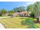 Charming single-story house with landscaping and a paved driveway at 5452 Saint Regis Way, Port Orange, FL 32128