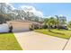 Beautiful home exterior with a well-manicured lawn and driveway at 5452 Saint Regis Way, Port Orange, FL 32128