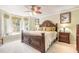 Large main bedroom with plush bedding and a bay window at 5452 Saint Regis Way, Port Orange, FL 32128