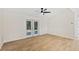 Bright living room with tile floors and French doors leading to the backyard at 1004 W 7Th St, New Smyrna Beach, FL 32168