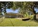 Charming backyard with deck and large shade tree at 1004 W 7Th St, New Smyrna Beach, FL 32168