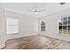 Bright bedroom with wood-look floors, ceiling fan, and ample natural light at 1004 W 7Th St, New Smyrna Beach, FL 32168