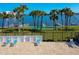Community pool area with lounge chairs and water view at 721 S Beach St # 214A, Daytona Beach, FL 32114