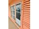 Condominium building entrance with peach walls and white door at 721 S Beach St # 214A, Daytona Beach, FL 32114