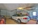 Garage with car, storage shelves, and golf clubs at 11 Andrea Dr, New Smyrna Beach, FL 32168