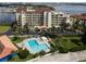 L-shaped community pool with surrounding patio furniture at 731 Marina Point Dr # 7310, Daytona Beach, FL 32114