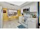 Bright kitchen with white cabinets, tile backsplash, and a breakfast nook at 731 Marina Point Dr # 7310, Daytona Beach, FL 32114