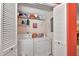Well-equipped laundry room with washer, dryer, and ample storage shelves at 731 Marina Point Dr # 7310, Daytona Beach, FL 32114