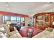 Living room with a view, white sofas, and a large wooden cabinet at 731 Marina Point Dr # 7310, Daytona Beach, FL 32114