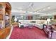 Living room with sectional sofa, wooden cabinet, and red carpet at 731 Marina Point Dr # 7310, Daytona Beach, FL 32114