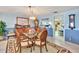 Bright dining room with wooden table and chairs, and view into kitchen at 731 Marina Point Dr # 7310, Daytona Beach, FL 32114