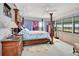 Spacious bedroom with a large four-poster bed and water views at 731 Marina Point Dr # 7310, Daytona Beach, FL 32114