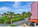 View of parking lot with tropical landscaping and water views at 731 Marina Point Dr # 7310, Daytona Beach, FL 32114