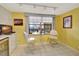 Kitchen breakfast nook with yellow walls and glass table at 731 Marina Point Dr # 7310, Daytona Beach, FL 32114