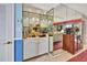 Wet bar with mirrored backsplash, white cabinets, and glass shelving at 731 Marina Point Dr # 7310, Daytona Beach, FL 32114