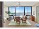 Sunroom with wicker furniture, a glass table, and stunning water views at 731 Marina Point Dr # 7310, Daytona Beach, FL 32114