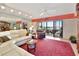 Living room with a white leather sectional sofa, a view, and a balcony at 731 Marina Point Dr # 7310, Daytona Beach, FL 32114