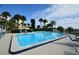 Inviting community swimming pool with lounge chairs and patio area at 731 Marina Point Dr # 7310, Daytona Beach, FL 32114
