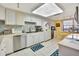 Well-equipped kitchen with white cabinets, stainless steel appliances, and tiled floors at 731 Marina Point Dr # 7310, Daytona Beach, FL 32114