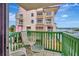 Relaxing balcony with chairs and small table, overlooking the water at 731 Marina Point Dr # 7310, Daytona Beach, FL 32114